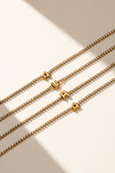 Gold initial bracelet with sparkling tennis style chain and alphabet letter charm, shown as a dainty personalized bracelet for her. Minimalist letter bracelet jewelry designed as an everyday gold bracelet, birthday gift, bridesmaid gift, and custom alphabet bracelet with A to Z letter options.