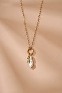 Personalized freshwater pearl birthstone necklace featuring a natural pearl charm paired with a custom birth month gemstone. Dainty gold necklace available in 12 birthstone colors including garnet, amethyst, aquamarine, emerald, ruby, sapphire, topaz and more. Minimalist everyday jewelry designed for layering and daily wear. Meaningful personalized gift for women, daughters, sisters, friends and bridesmaids with a timeless and elegant style.
