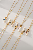 Personalized freshwater pearl birthstone necklace featuring a natural pearl charm paired with a custom birth month gemstone. Dainty gold necklace available in 12 birthstone colors including garnet, amethyst, aquamarine, emerald, ruby, sapphire, topaz and more. Minimalist everyday jewelry designed for layering and daily wear. Meaningful personalized gift for women, daughters, sisters, friends and bridesmaids with a timeless and elegant style.
