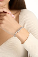 Close-up of a silver tone double row crystal bangle on the wrist