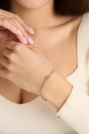 Gold initial bracelet with sparkling tennis style chain and alphabet letter charm, shown as a dainty personalized bracelet for her. Minimalist letter bracelet jewelry designed as an everyday gold bracelet, birthday gift, bridesmaid gift, and custom alphabet bracelet with A to Z letter options.