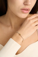 Gold initial bracelet with sparkling tennis style chain and alphabet letter charm, shown as a dainty personalized bracelet for her. Minimalist letter bracelet jewelry designed as an everyday gold bracelet, birthday gift, bridesmaid gift, and custom alphabet bracelet with A to Z letter options.