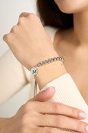 Silver beaded bolo bracelet with engraved letter M initial charm on wrist — AURA Jewelry
