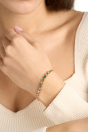 Colorful stone bracelet with multicolor gemstones in a dainty tennis bracelet style, shown as a gift for her and everyday jewelry. Rainbow bracelet with round bezel set stones designed as a delicate gemstone bracelet, stacking bracelet, and colorful bracelet for women.

