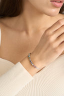 Dainty colorful stone bracelet with round multicolor gems arranged in a sleek tennis bracelet design. Rainbow gemstone bracelet for women styled as a gift for her, stacking bracelet, and elegant everyday jewelry piece.