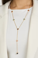 Colorful heart lariat Y necklace worn over a white top, close view