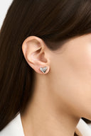 Textured heart stud earrings in gold and silver with a sculptural hammered finish, shown as minimalist heart earrings for women. Gold heart earrings and silver heart studs displayed as romantic gift jewelry, everyday stud earrings, and modern heart shaped earrings with a soft reflective surface.