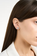 Textured heart stud earrings in gold and silver with a sculptural hammered finish, shown as minimalist heart earrings for women. Gold heart earrings and silver heart studs displayed as romantic gift jewelry, everyday stud earrings, and modern heart shaped earrings with a soft reflective surface.