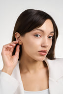 Textured heart stud earrings in gold and silver with a sculptural hammered finish, shown as minimalist heart earrings for women. Gold heart earrings and silver heart studs displayed as romantic gift jewelry, everyday stud earrings, and modern heart shaped earrings with a soft reflective surface.