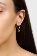 Gold heart hoop earrings with dangling gold heart charm worn on model ear - AURA Jewelry