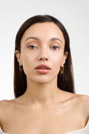 Model wearing heart hoop earrings with gold and red enamel heart charms - AURA Jewelry
