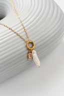 Personalized freshwater pearl birthstone necklace featuring a natural pearl charm paired with a custom birth month gemstone. Dainty gold necklace available in 12 birthstone colors including garnet, amethyst, aquamarine, emerald, ruby, sapphire, topaz and more. Minimalist everyday jewelry designed for layering and daily wear. Meaningful personalized gift for women, daughters, sisters, friends and bridesmaids with a timeless and elegant style.
