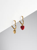 Heart shaped hoop earrings with gold and red enamel heart charm pendants on white surface - AURA Jewelry