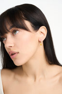 Gold birthstone huggie earrings with crystal huggie hoops and pear shaped gemstone drops arranged in several birth month color options. These dainty drop earrings are shown as elegant gift for her jewelry, birthday gift earrings, minimalist gold earrings, and personalized birth month earrings. Teardrop gemstone charm earrings with a refined everyday look, perfect for bridesmaid gifts, anniversary gifts, or stacking with other delicate jewelry pieces.

